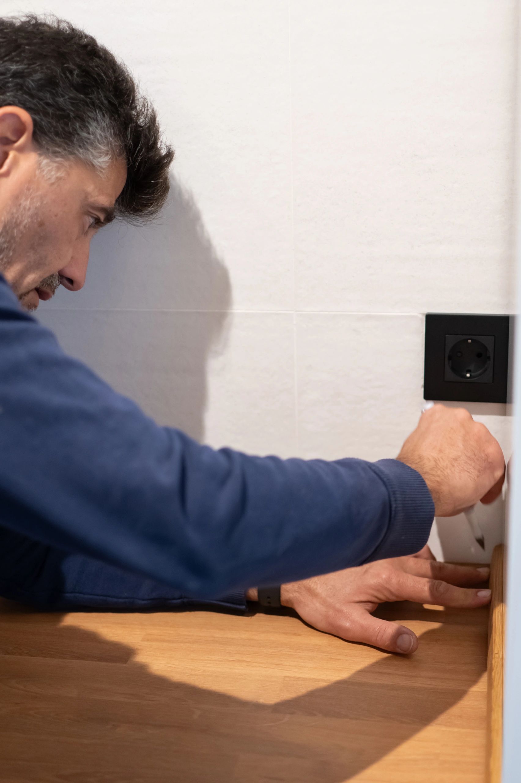 Tradesperson fitting a modern kitchen worktop during a refurbishment project